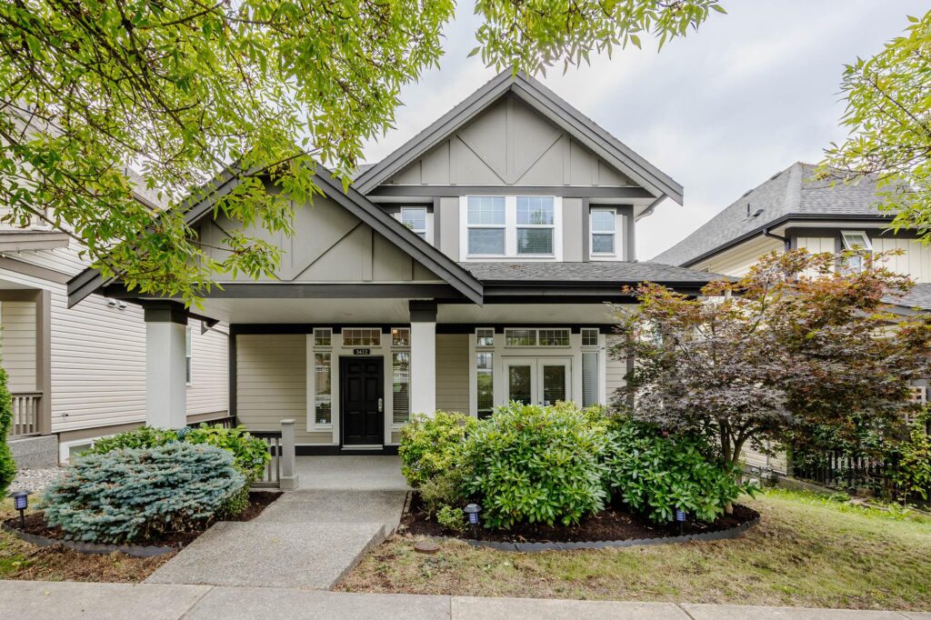 Landscaped detached home with shrubs and front garden