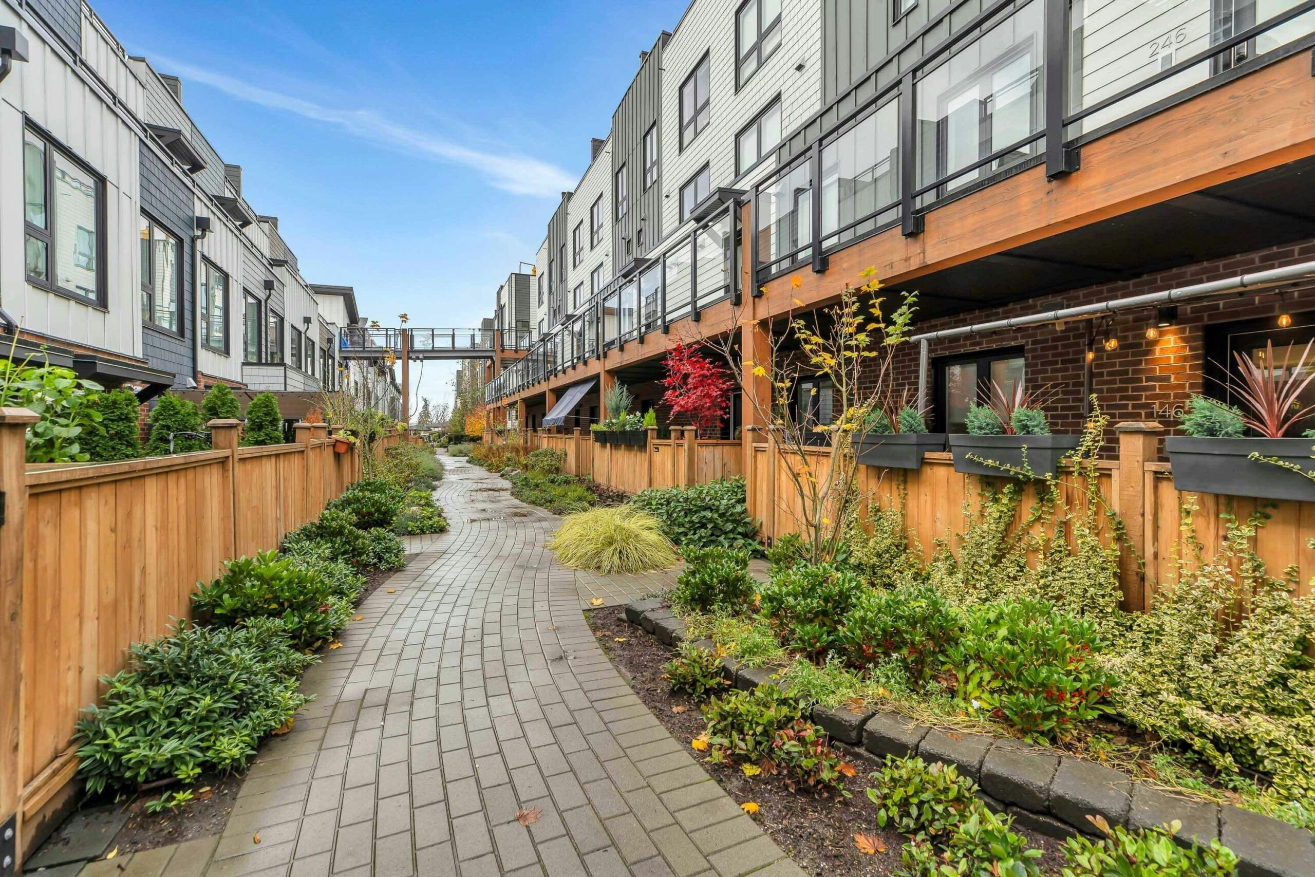 Townhouse walkway with landscaped garden beds and shrubs