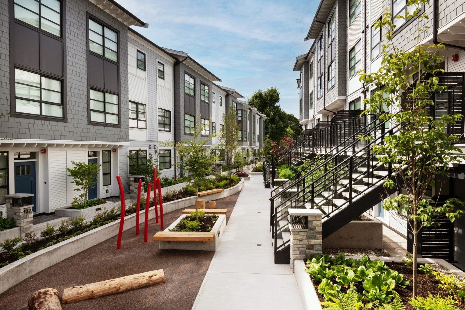 Modern townhouse courtyard with shared landscaping and planted garden beds
